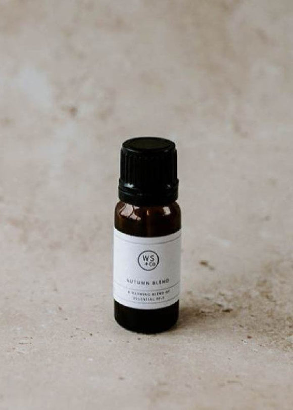 Small brown bottle with a black cap on a beige background