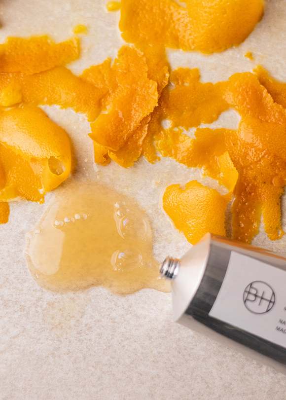 Close-up of a tube of balm with yellow balm on a white background