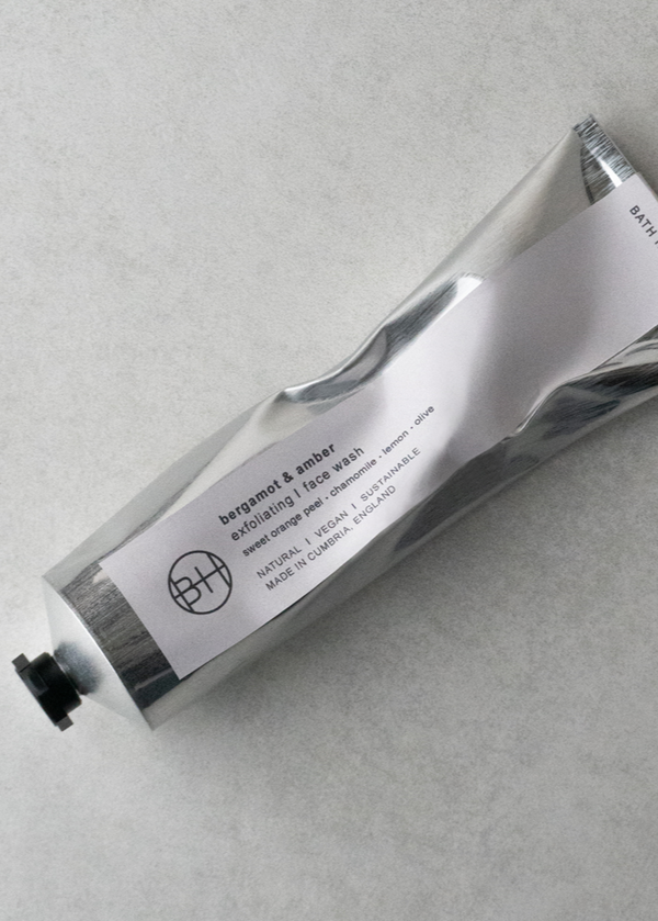 Hand cream tube with a label on a gray background