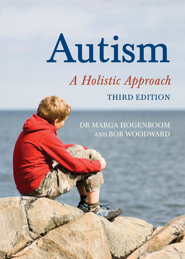 Book cover of 'Autism: A Holistic Approach' with a child sitting on rocks by the water.