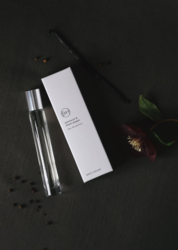 Clear glass bottle with white label on a dark surface