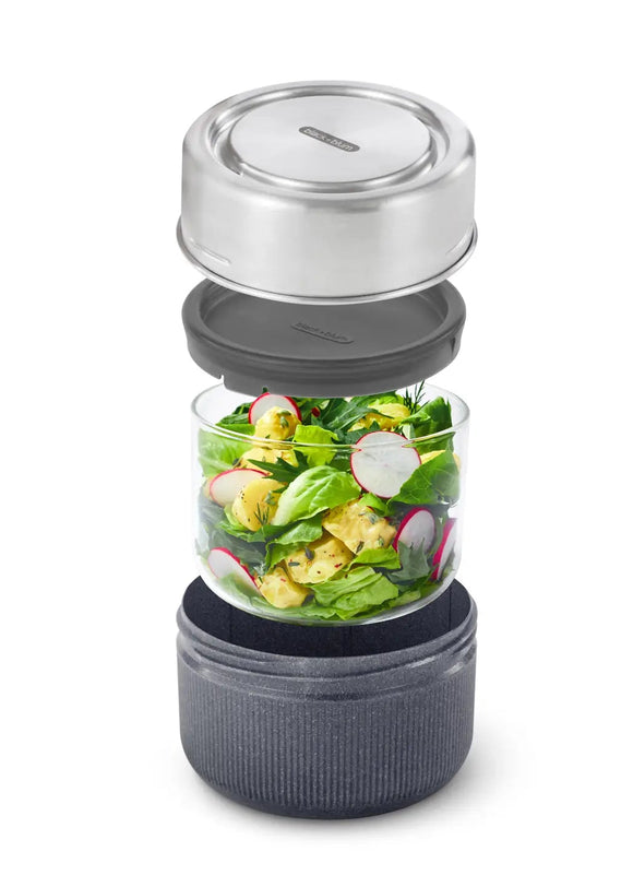 Salad container with a silver lid and black base on a white background