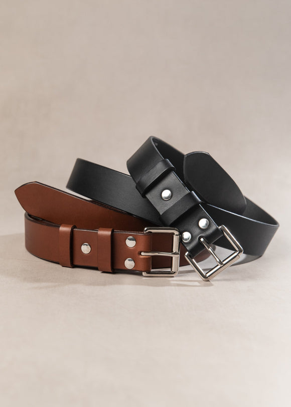 Two leather belts, one brown and one black, on a beige background.
