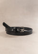 Black belt with a silver buckle on a beige background
