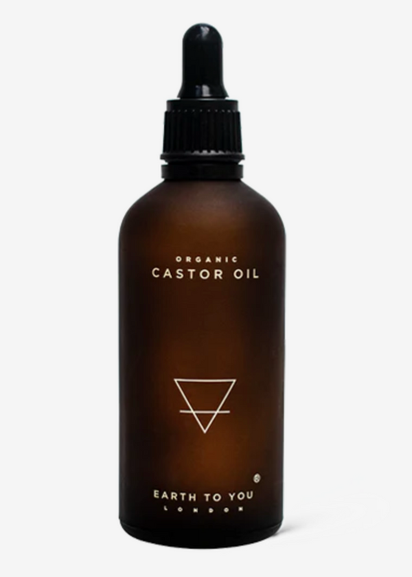 A bottle of Earth to You Castor Oil with a dropper, labeled 100ml and indicating it's for hair and skin care.