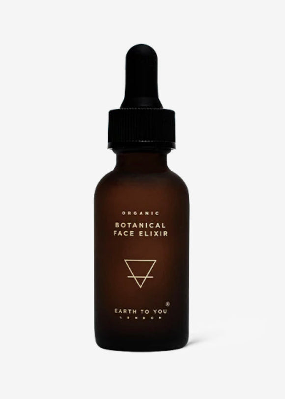 A brown glass bottle with a dropper containing an organic botanical face elixir, labeled with the brand 'Earth To You'.