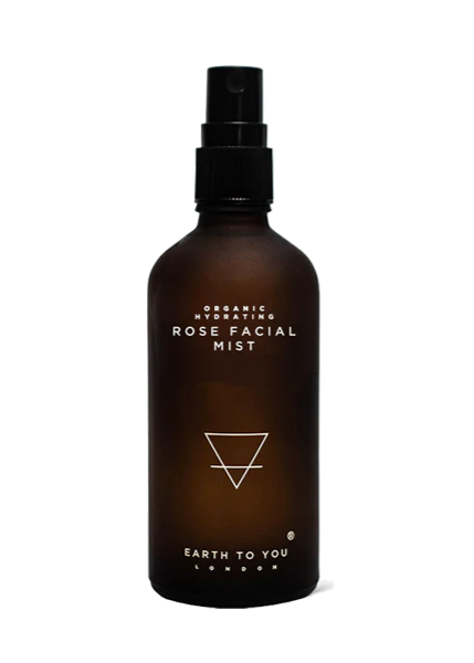 A brown bottle with a spray nozzle labeled 'Organic Rose Facial Mist' from Earth to You.