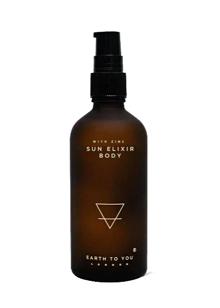 A brown glass bottle with a black cap labeled 'Sun Elixir Body' with the brand 'Earth to You'.