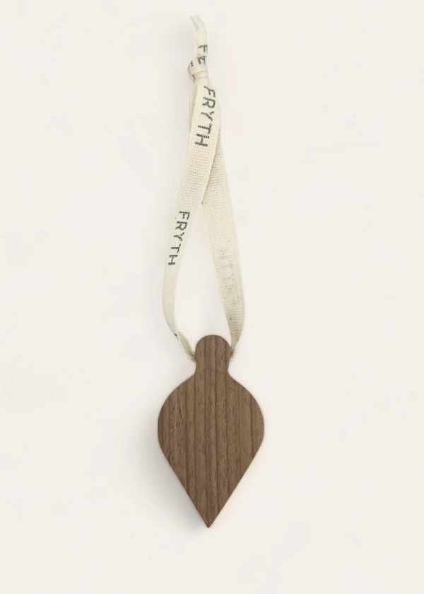 Wooden christmas decoration with a ribbon on a white background