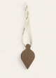 Wooden christmas decoration with a ribbon on a white background