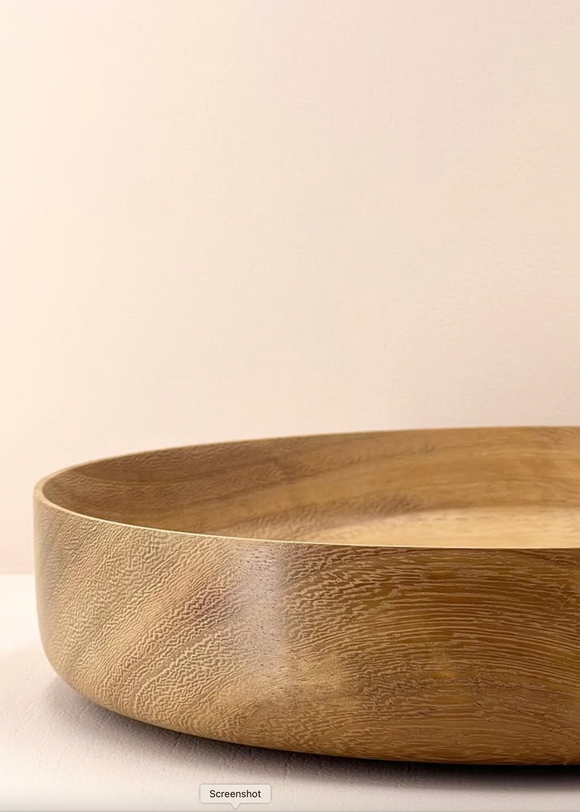 Wooden bowl on a light beige background