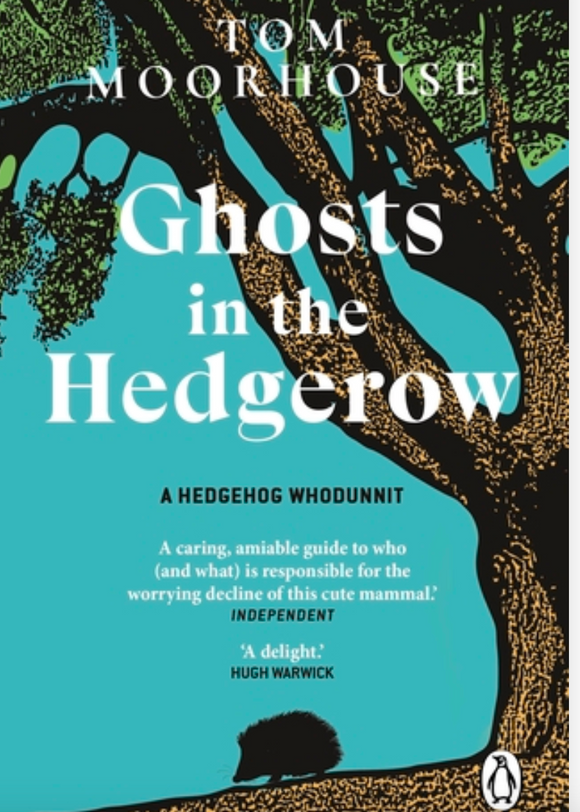 This image features the cover of the book titled "Ghosts in the Hedgerow" by Tom Moorhouse. The cover depicts a serene yet intriguing scene with a hedgehog nestled under a tree, partially hidden by the lush green leaves.