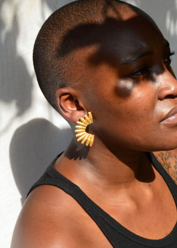 Gold fan Quazi Design earring on model