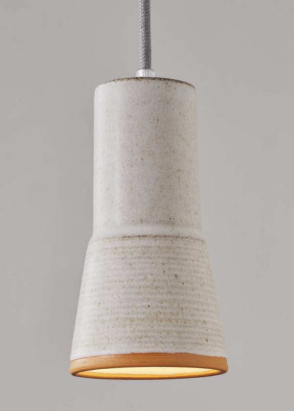Cylindrical pendant light with textured design on a gray background