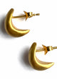 A pair of gold crescent moon earrings with a brushed finish, showing the back closure mechanism.