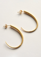 Gold hoop earrings on a light gray background