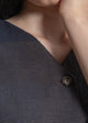 Close-up of a textured gray garment with a button