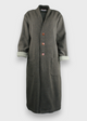 A long gray wool coat with wooden buttons, fully lined, displayed on a mannequin.