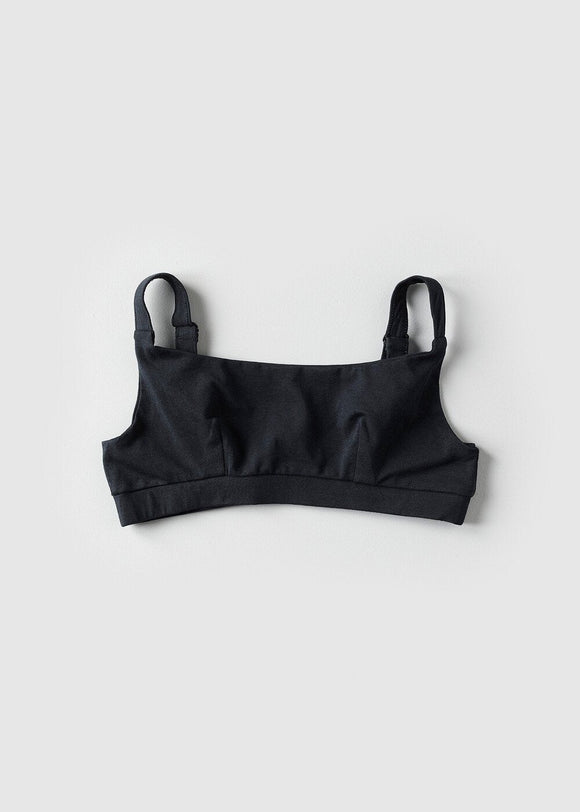 A beige organic cotton full crop top with covered adjustable straps and underband, displayed against a neutral background.