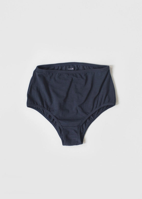 A pair of high-waisted beige organic cotton knickers with binding at the waist and legs.