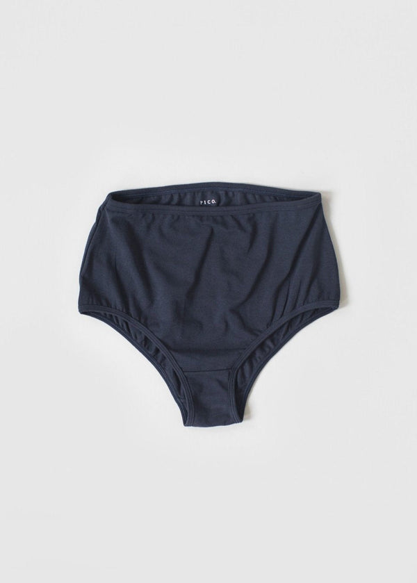 A pair of high-waisted beige organic cotton knickers with binding at the waist and legs.