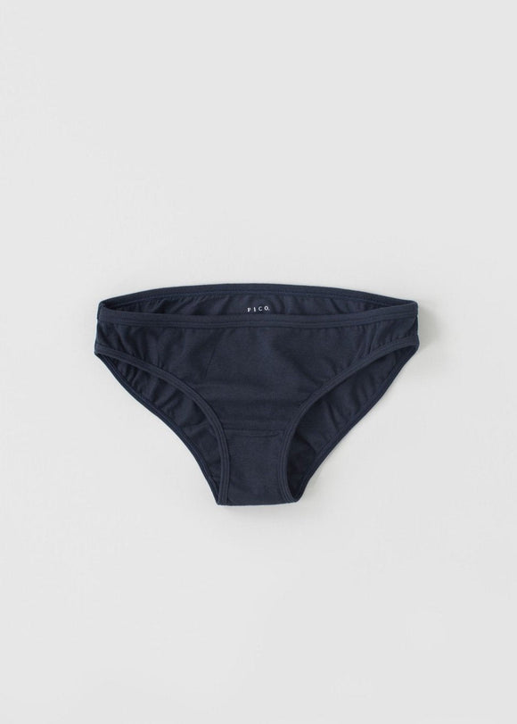 A pair of low waist knickers in a natural beige color, laid flat on a plain background.