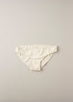 A pair of low waist knickers in a natural beige color, laid flat on a plain background.
