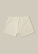 A pair of beige, organic cotton jersey trunk shorts with a slim fitting leg and enclosed elastic waistband.