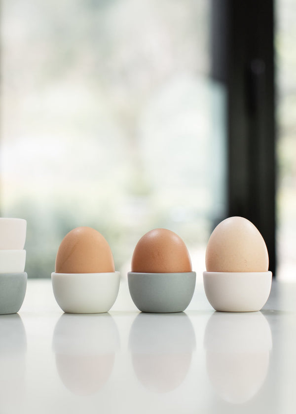 Three eggs on a white surface with a blurred background