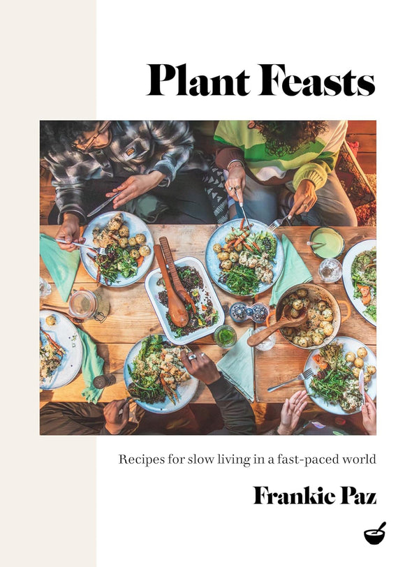Book cover of 'Plant Feasts' with people around a table eating a meal.