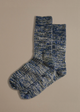A pair of chunky marbled wool socks in shades of blue and green, laid flat on a neutral background.