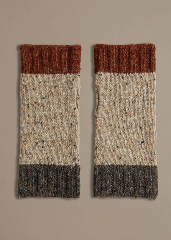 A pair of Donegal wrist warmers with beige, gray, and red color blocks, laid flat on a neutral background.
