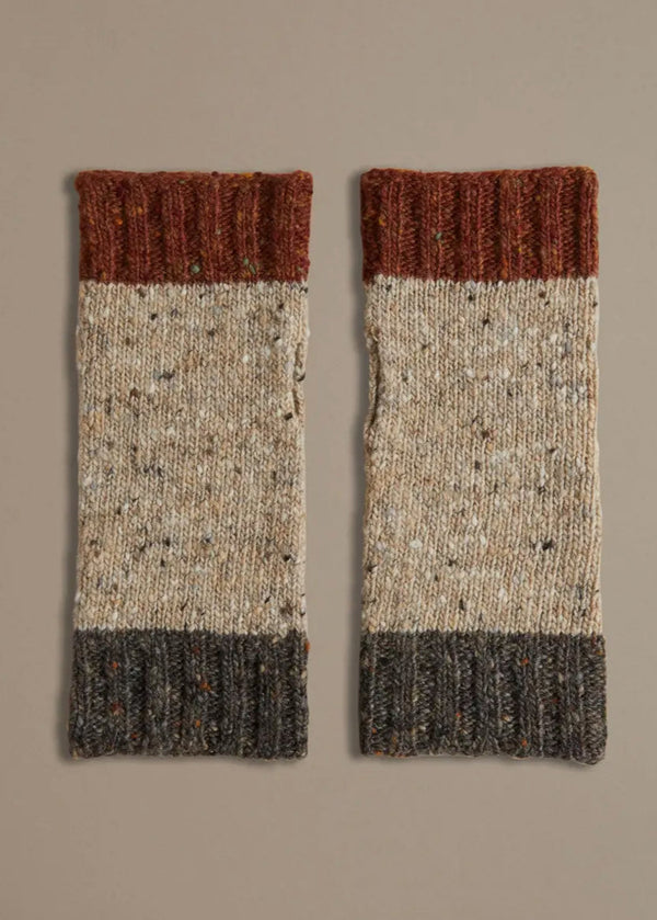 A pair of Donegal wrist warmers with beige, gray, and red color blocks, laid flat on a neutral background.