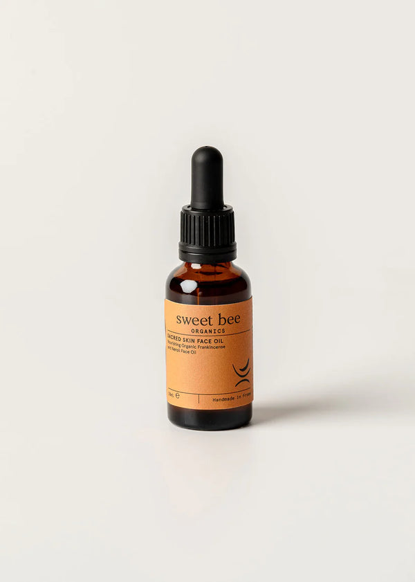 Bottle of sweet bee organic hair face oil on a white background
