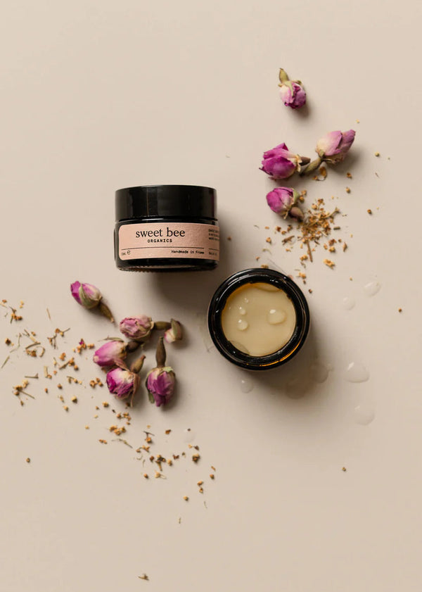 Two jars of 'sweet bee' cream with dried flowers on a beige background