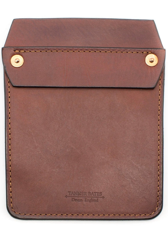 A brown leather pocket protector with brass snap closures, featuring the Tanner Bates brand embossed at the bottom.