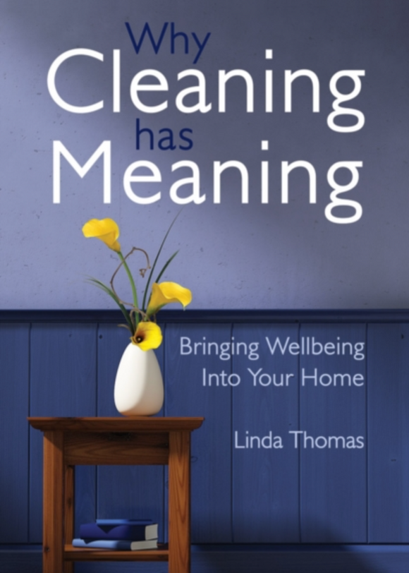 Book cover of 'Why Cleaning has Meaning' by Linda Thomas with a vase of flowers on a wooden table against a blue wall.