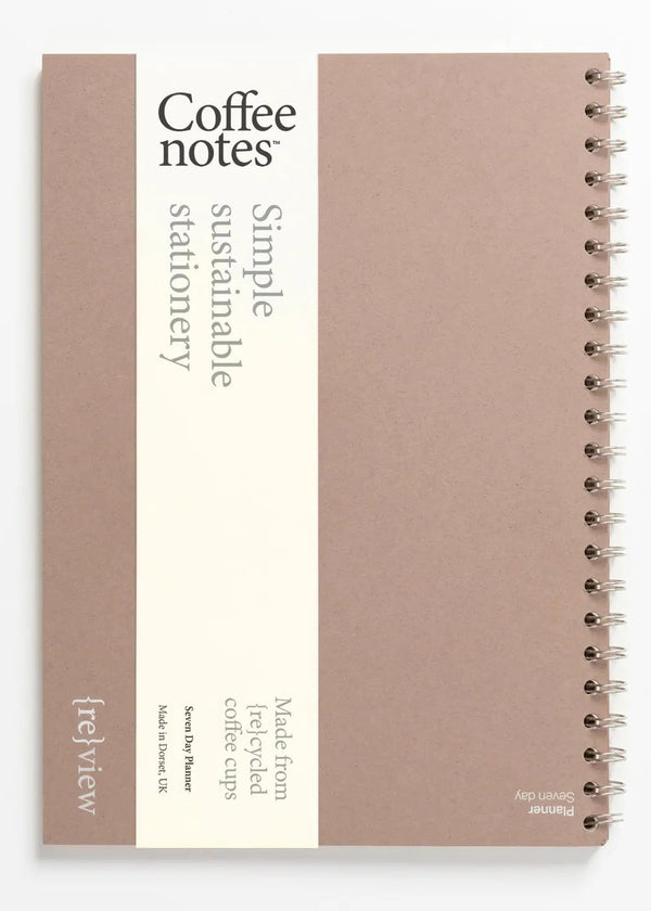 Sustainable stationery planner made from recycled coffee cups on a white background