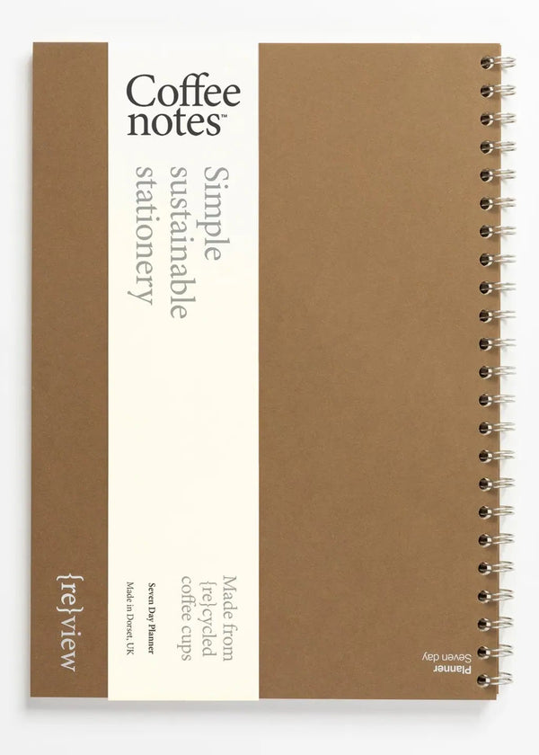Sustainable stationery planner made from recycled coffee cups on a white background