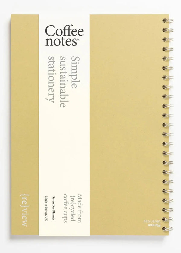 Sustainable stationery planner made from recycled coffee cups on a white background