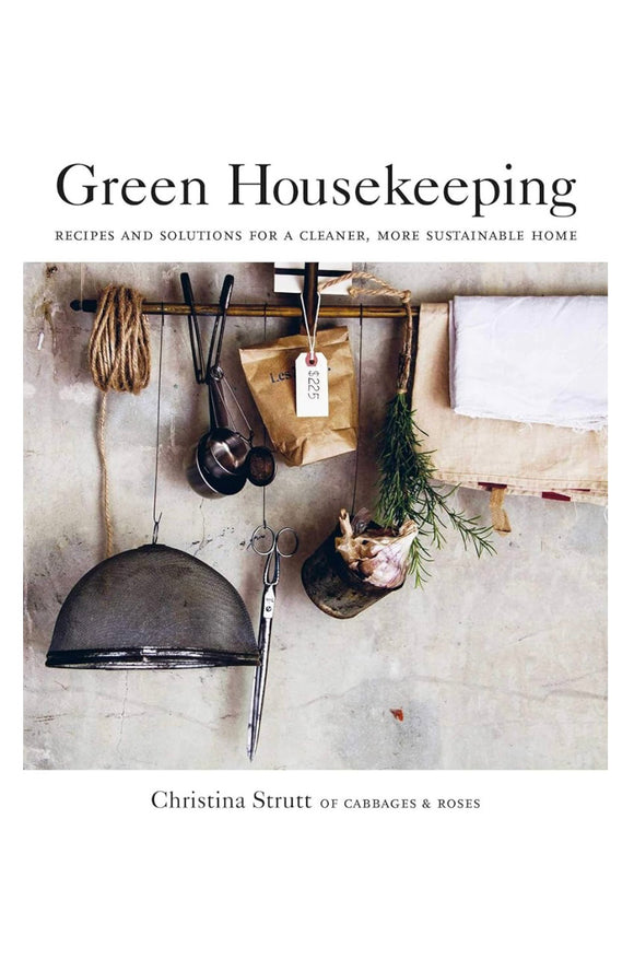 Book cover of 'Green Housekeeping' with rustic kitchen elements and text.