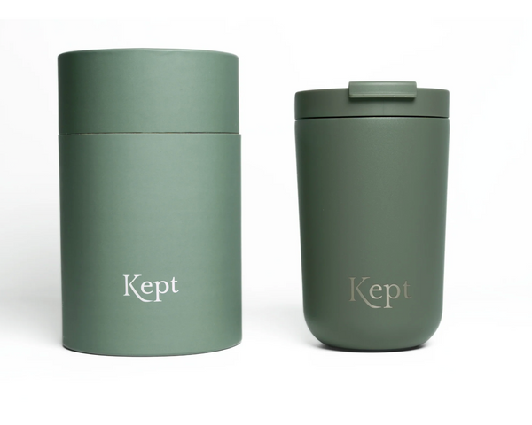 Two green tumblers with 'Kept' branding on a white background