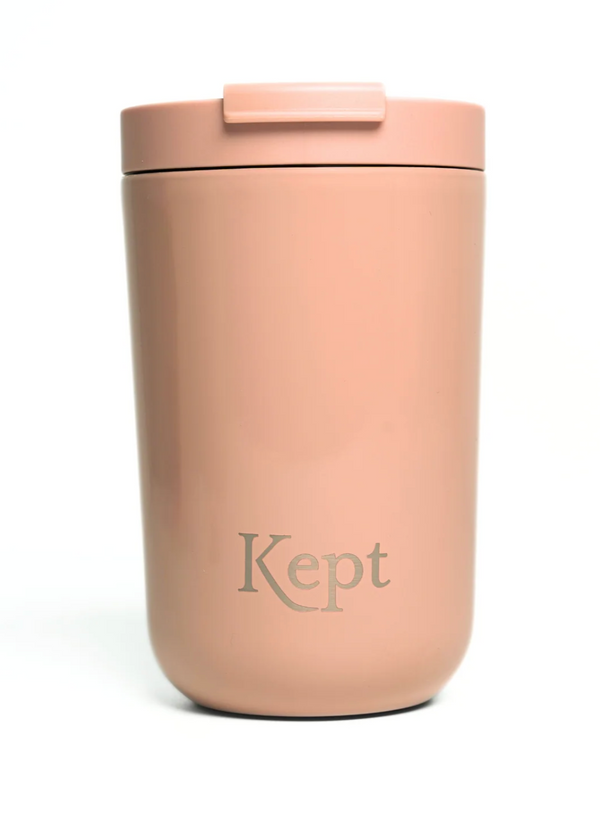Pink thermos with 'Kept' branding on a white background