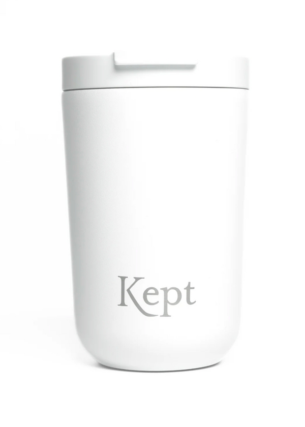 White tumbler with 'Kept' branding on a white background