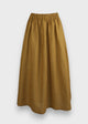 A mustard yellow linen gather skirt with an elastic waistband, in-seam pockets, and mid-calf length.