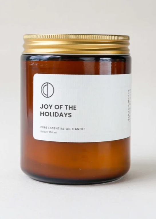 octo joy of the holidays candle in an amber glass jar