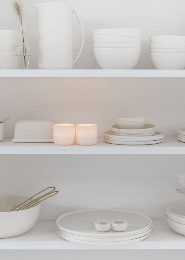 White ceramic dishes on a white shelf