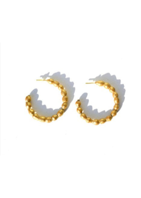Gold hoop earrings on a white background