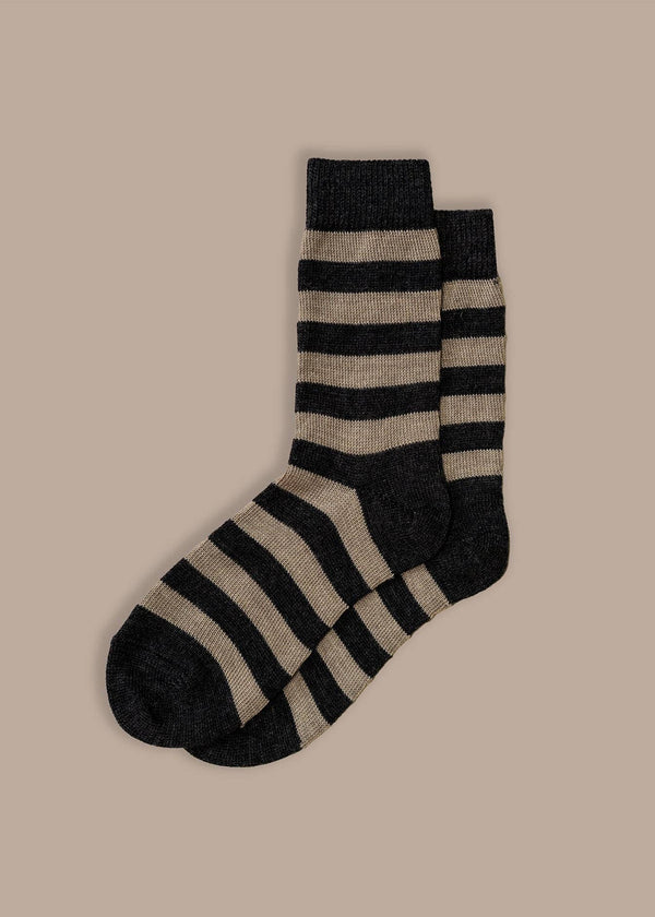 Striped socks with black and beige pattern on a beige background