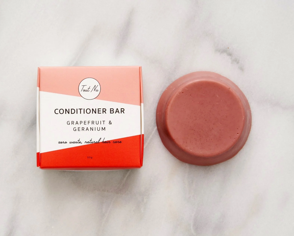 Conditioner bar and packaging on a marble surface